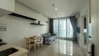 Modern living room with sleek design and balcony view in urban apartment.