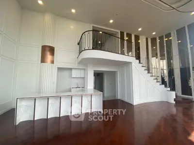 Stunning modern duplex with elegant staircase and open layout in luxurious apartment.