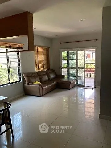 Spacious living room with large windows and modern furniture