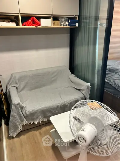 Cozy small living area with sofa, fan, and modern decor