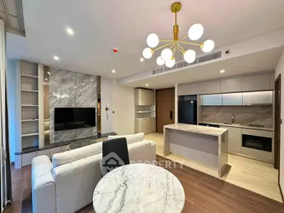 Modern open-plan living room with elegant marble accents and stylish lighting in a contemporary apartment.