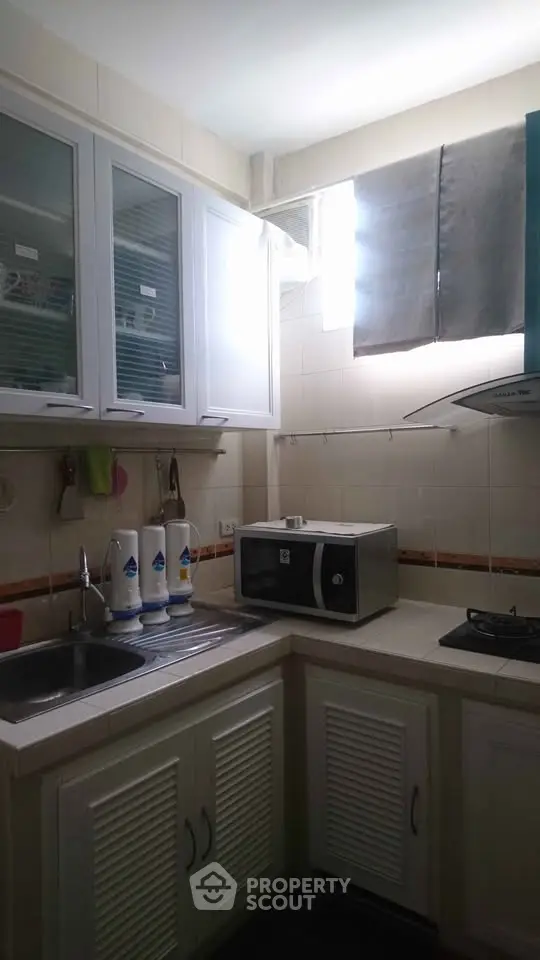 Cozy kitchen with microwave and gas stove in a compact layout