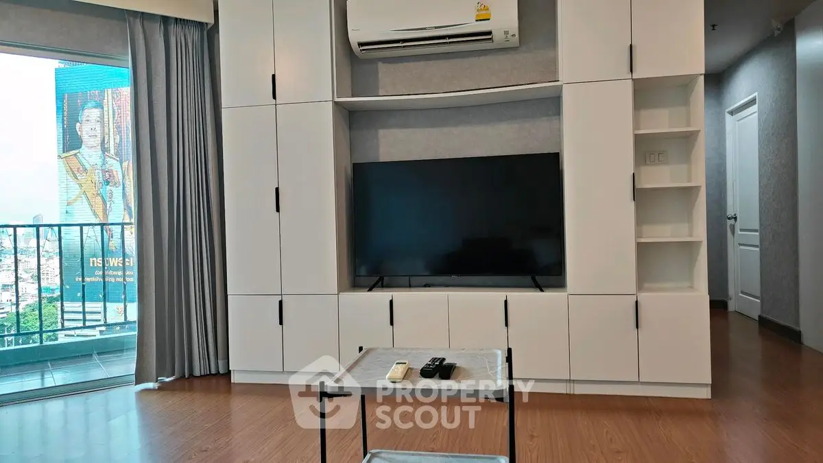 Modern living room with built-in TV unit and balcony view