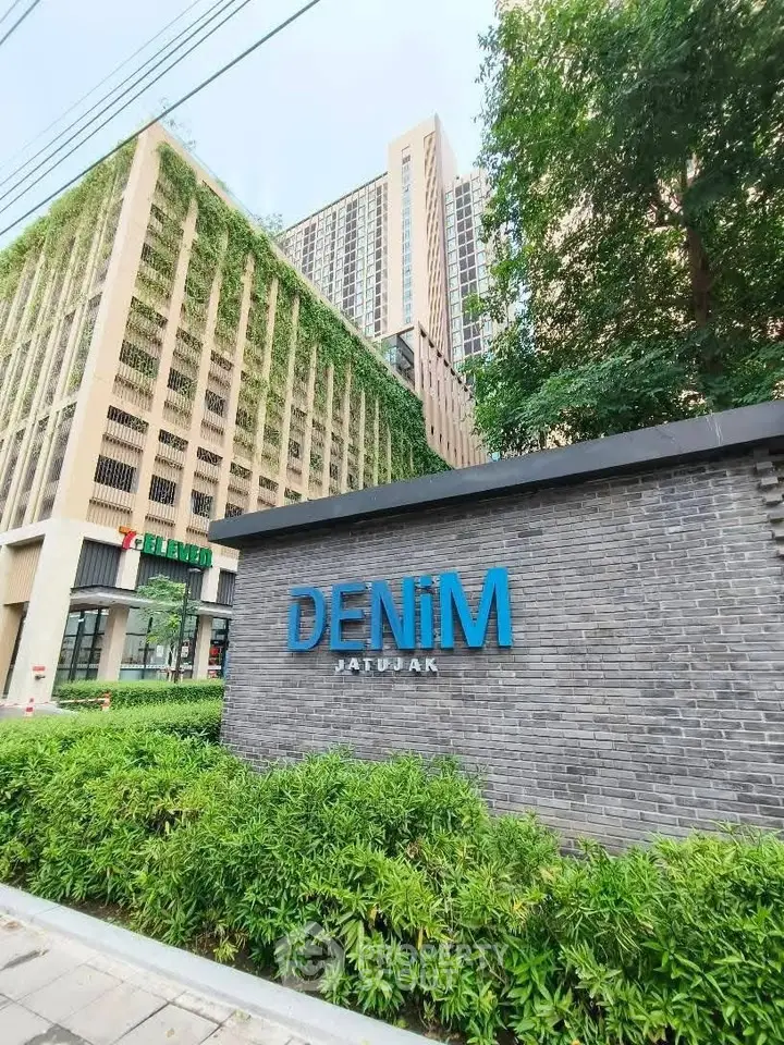 Modern urban condominium with lush greenery and stylish facade at Denim Jatujak.
