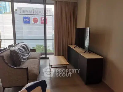 Modern living room with large TV and city view near Terminal 21.