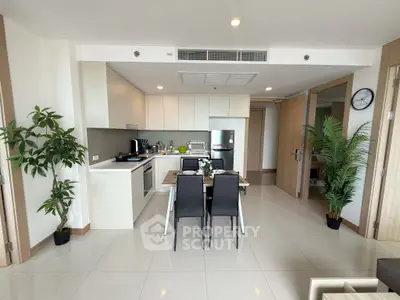 Modern open-layout kitchen and dining area with sleek appliances and stylish decor.