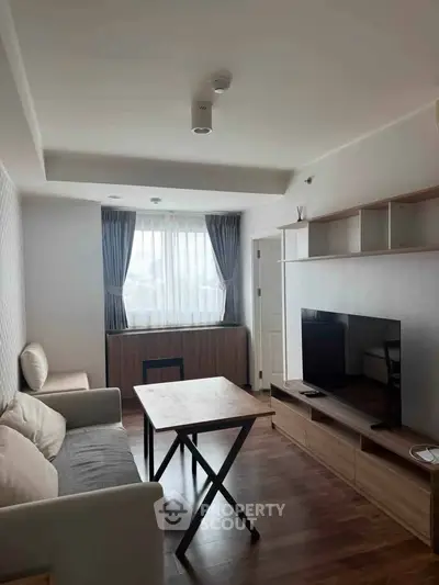 Modern living room with stylish furniture and natural light, perfect for relaxation and entertainment.