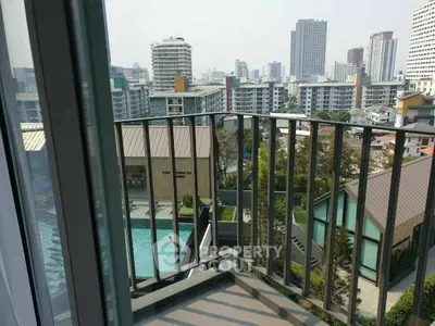 Urban balcony with cityscape view and pool, perfect for modern living.