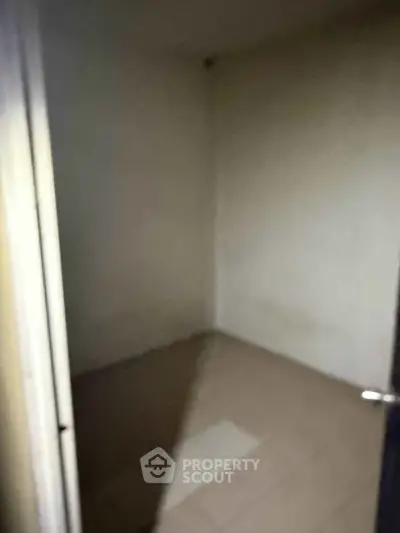Small empty room with tiled floor and plain walls, ideal for storage or utility use.