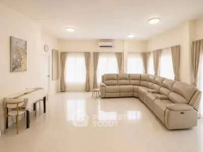 Spacious living room with elegant sectional sofa and natural light
