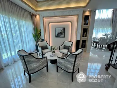 Elegant living room with polished tile flooring, modern furniture, and abundant natural light filtering through sheer curtains, creating a luxurious and inviting atmosphere.