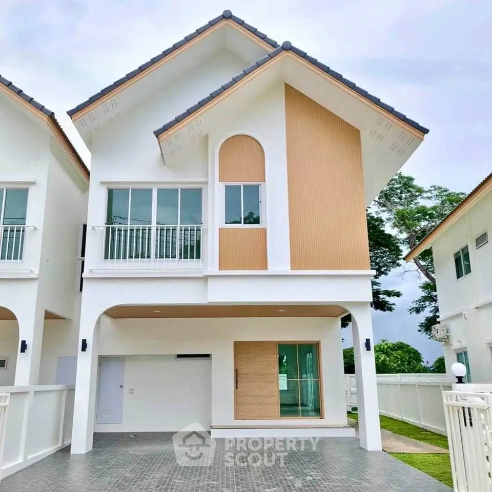 Modern two-story house with unique architectural design and spacious driveway.