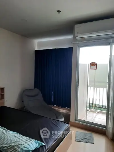 Cozy bedroom with balcony access and air conditioning in modern apartment