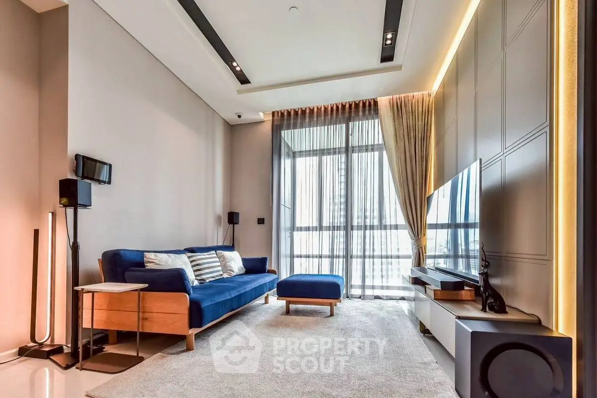 Modern living room with stylish furniture and large windows offering natural light.