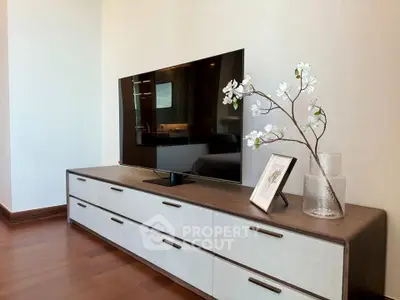 Modern living room with sleek TV stand and decorative elements, perfect for stylish home entertainment.