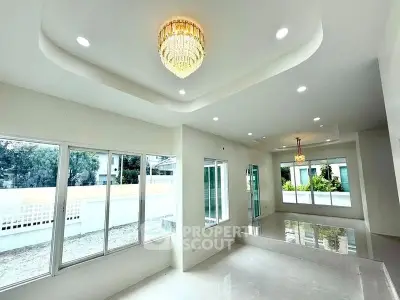 Spacious modern living room with elegant chandelier and large windows