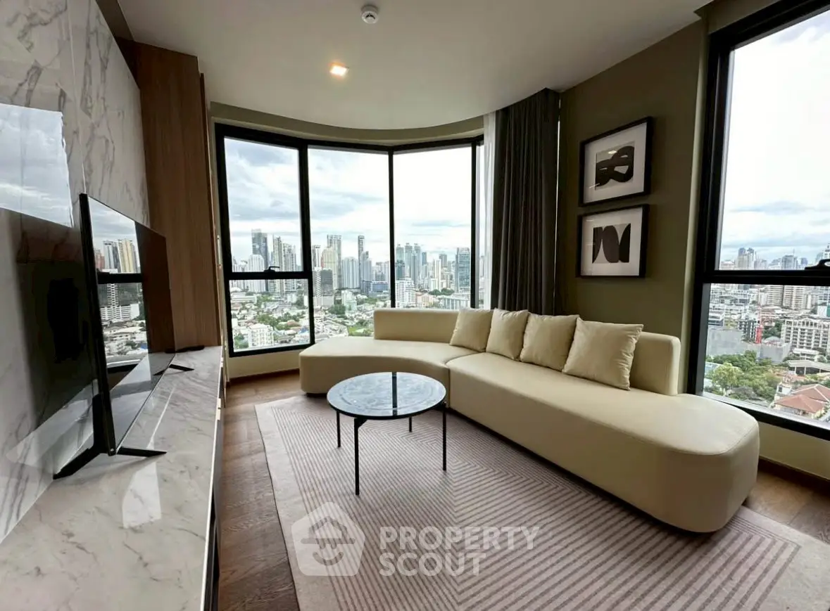 Luxurious living room with panoramic city views and modern furnishings in high-rise apartment.