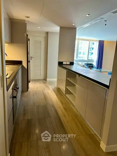 Modern kitchen with sleek cabinetry and open layout in a stylish apartment.