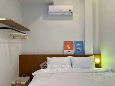 Cozy bedroom with modern air conditioning and stylish decor, perfect for relaxation.