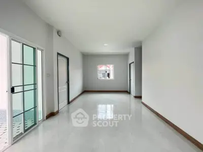 Spacious and bright interior with sleek tile flooring and modern design.