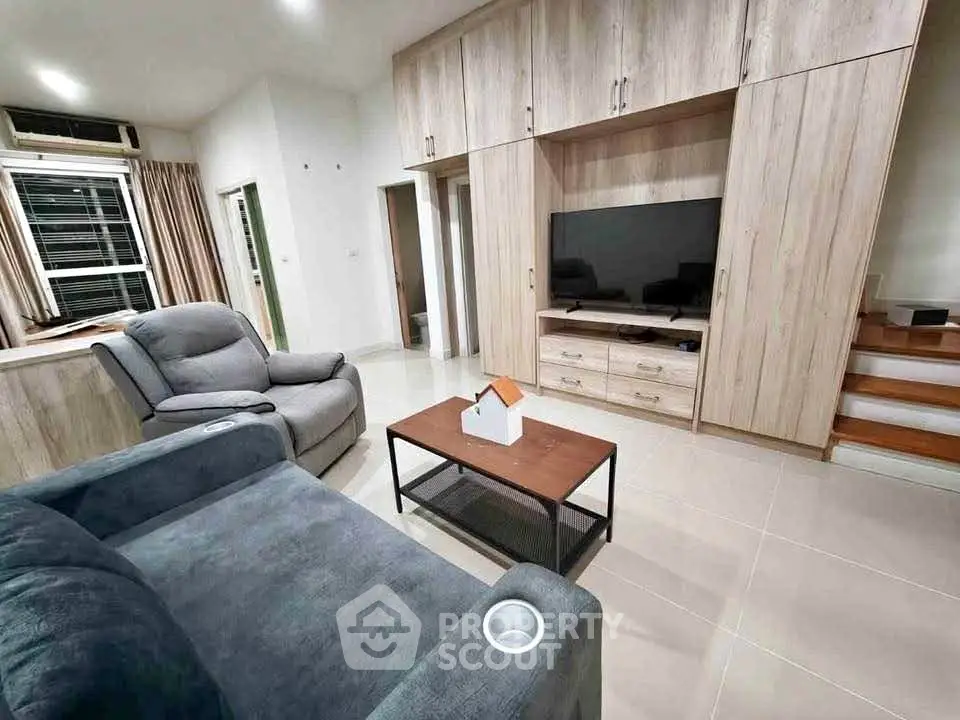 Modern living room with stylish furniture and built-in entertainment center