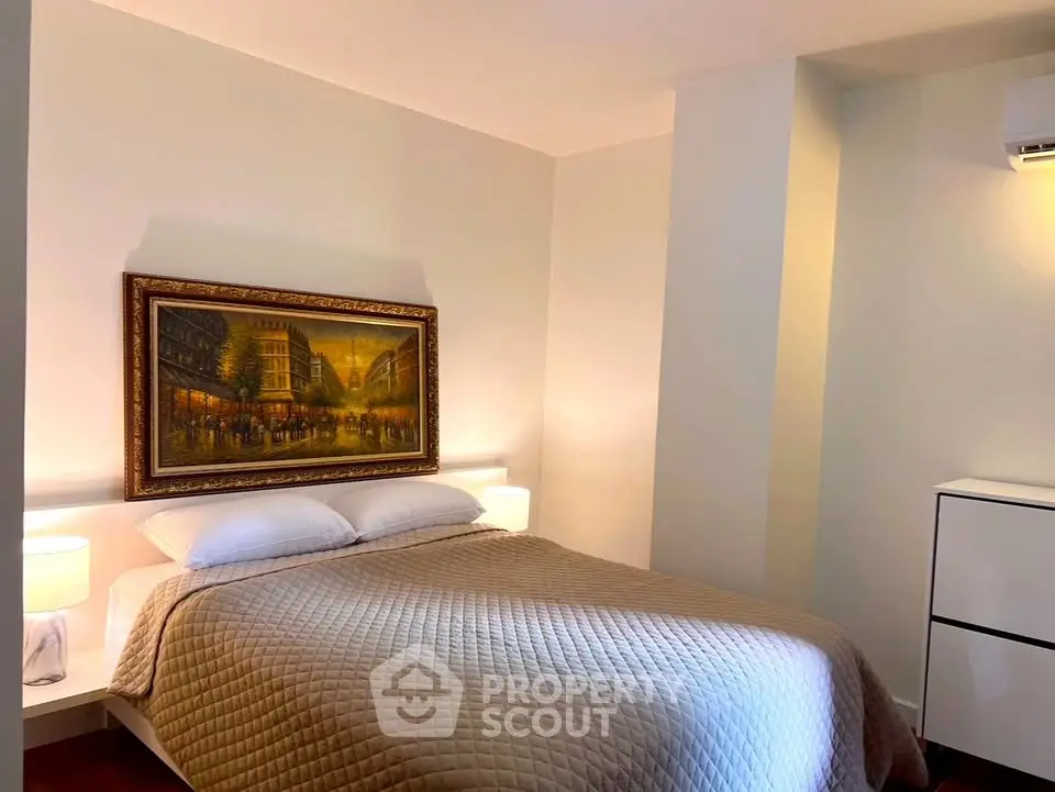 Cozy bedroom with elegant decor and warm lighting, perfect for relaxation.
