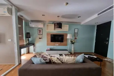 Modern living room with stylish decor, comfortable sofa, and wall-mounted TV in a cozy apartment.