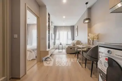 Modern open-plan living room with cozy seating and stylish decor in a contemporary apartment.