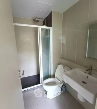 Modern bathroom with shower and sleek fixtures in a contemporary home.