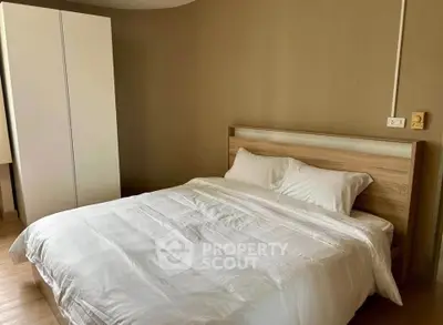 Cozy bedroom with modern wooden bed and white wardrobe, perfect for restful nights.