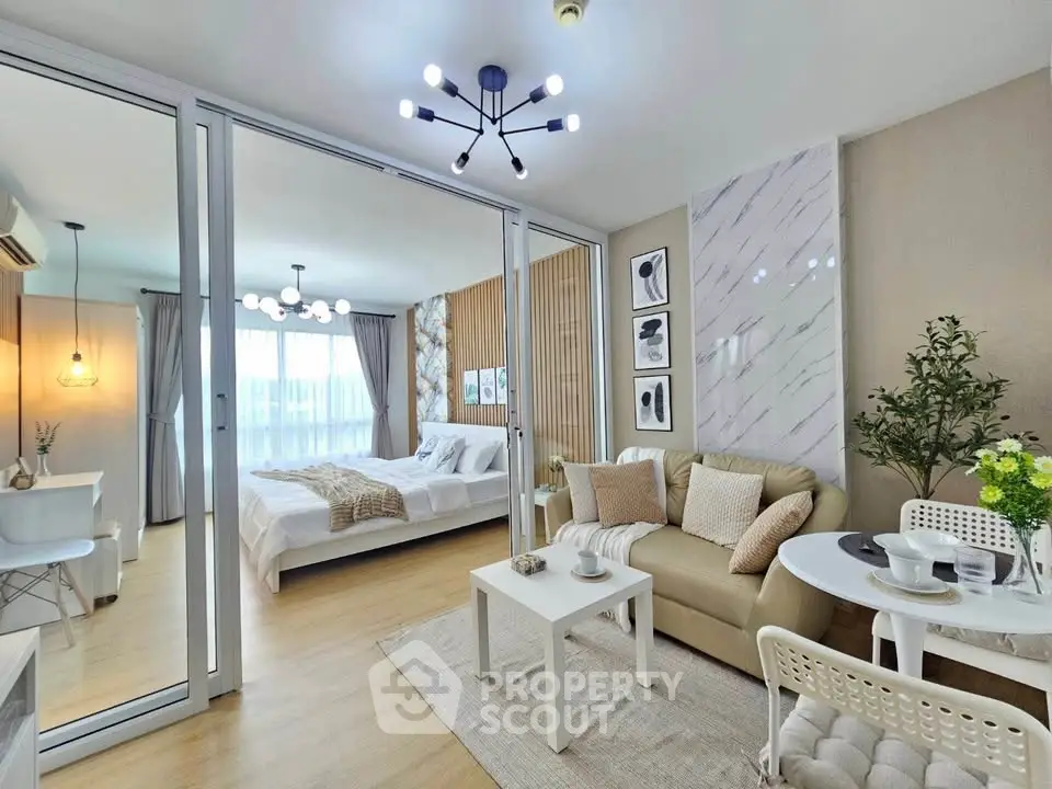 Modern open-plan living room and bedroom with stylish decor and natural light
