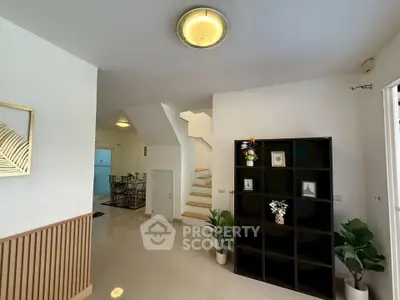 Modern interior with open layout, elegant staircase, and stylish decor in a contemporary home.