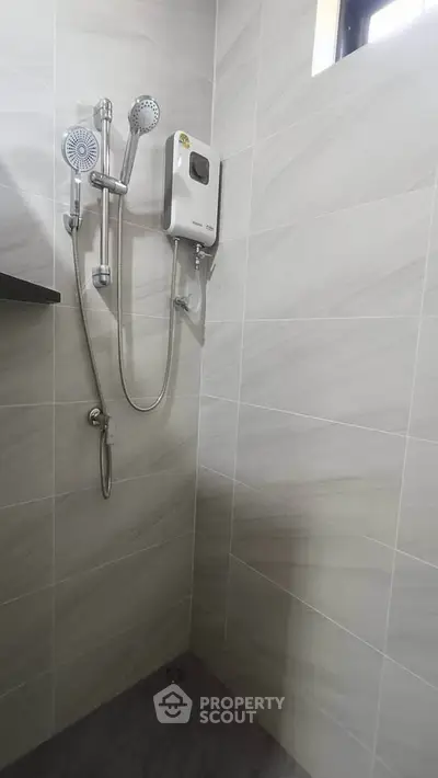 Modern bathroom with sleek shower fixtures and neutral tile design