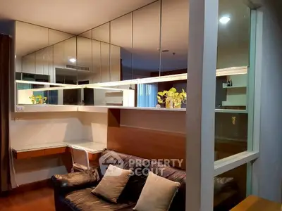 Modern living room with mirrored walls and cozy leather sofa