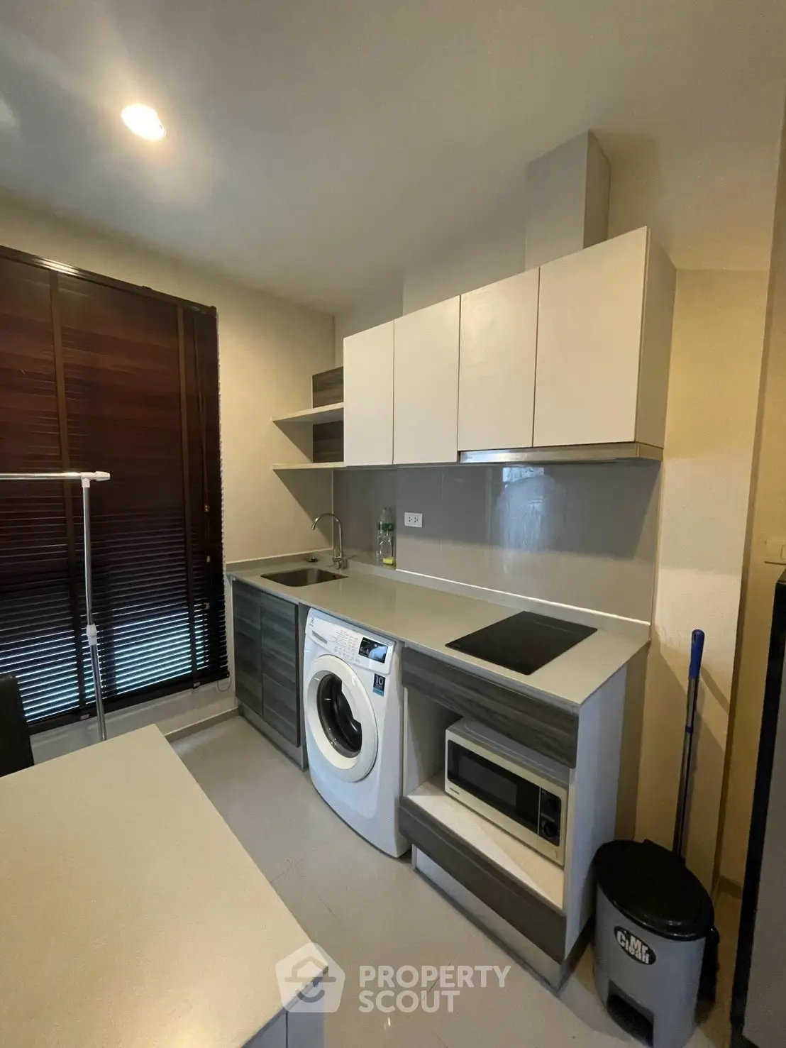 Modern kitchen with washing machine and sleek cabinetry