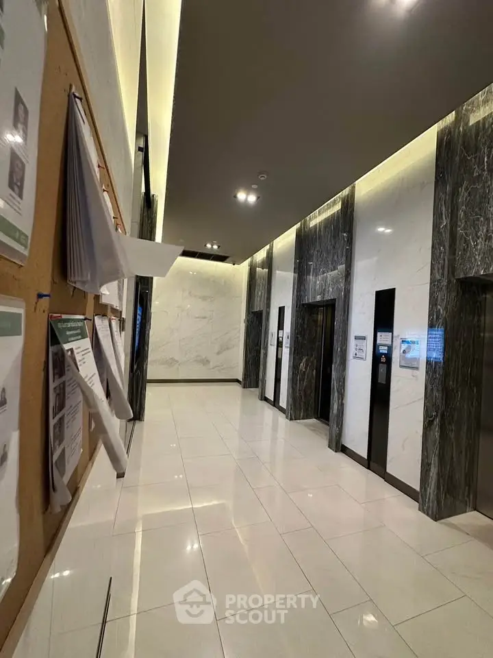 Modern building lobby with sleek elevators and marble finishes