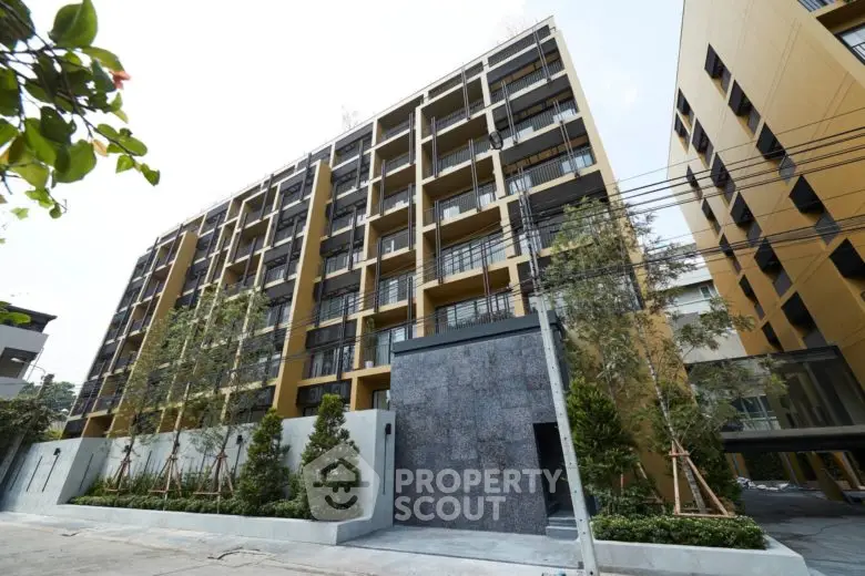 Modern apartment building with sleek design and lush greenery