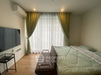 Cozy bedroom with modern decor, featuring a wall-mounted TV and large window with green curtains.