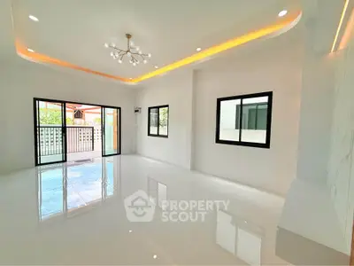Spacious modern living room with elegant lighting and large windows for natural light.