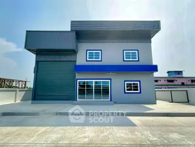 Modern industrial building with sleek design and spacious exterior, perfect for commercial use.