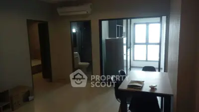 Modern apartment interior with dining area and large windows, showcasing a sleek and minimalist design.