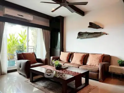 Stylish living room with modern furniture and large window overlooking greenery.