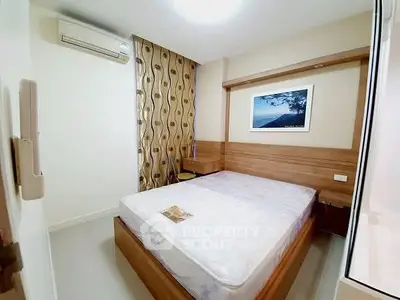 Cozy bedroom with modern decor and air conditioning unit, perfect for relaxation.