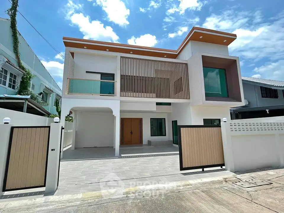 Modern two-story house with unique architectural design and spacious driveway