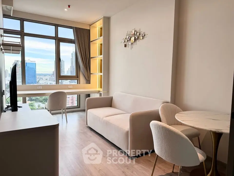 Modern living room with city view, featuring elegant furniture and large windows for natural light.