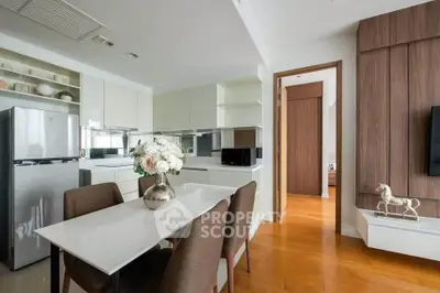 Modern kitchen and dining area with sleek design and wooden flooring