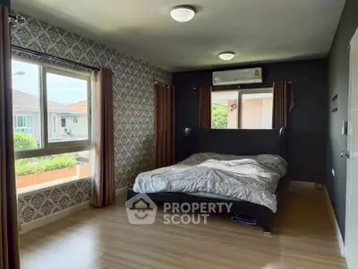 Spacious bedroom with large windows and modern decor