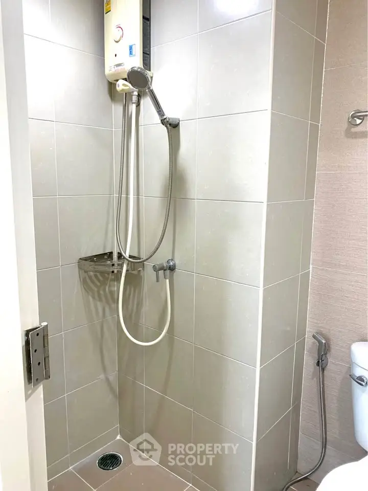 Modern bathroom with sleek shower and tiled walls