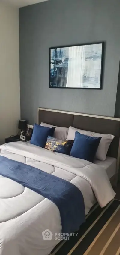 Elegant bedroom with modern decor and cozy bedding in a stylish apartment