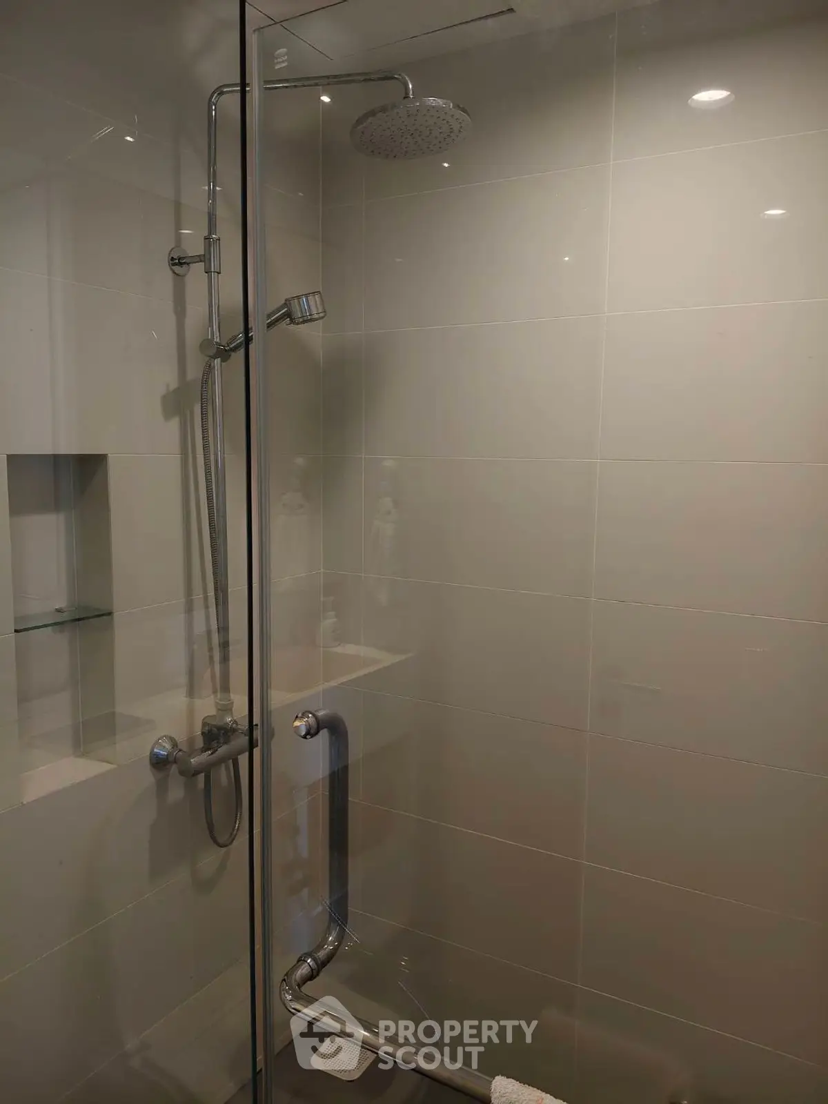 Modern bathroom with glass shower enclosure and sleek fixtures